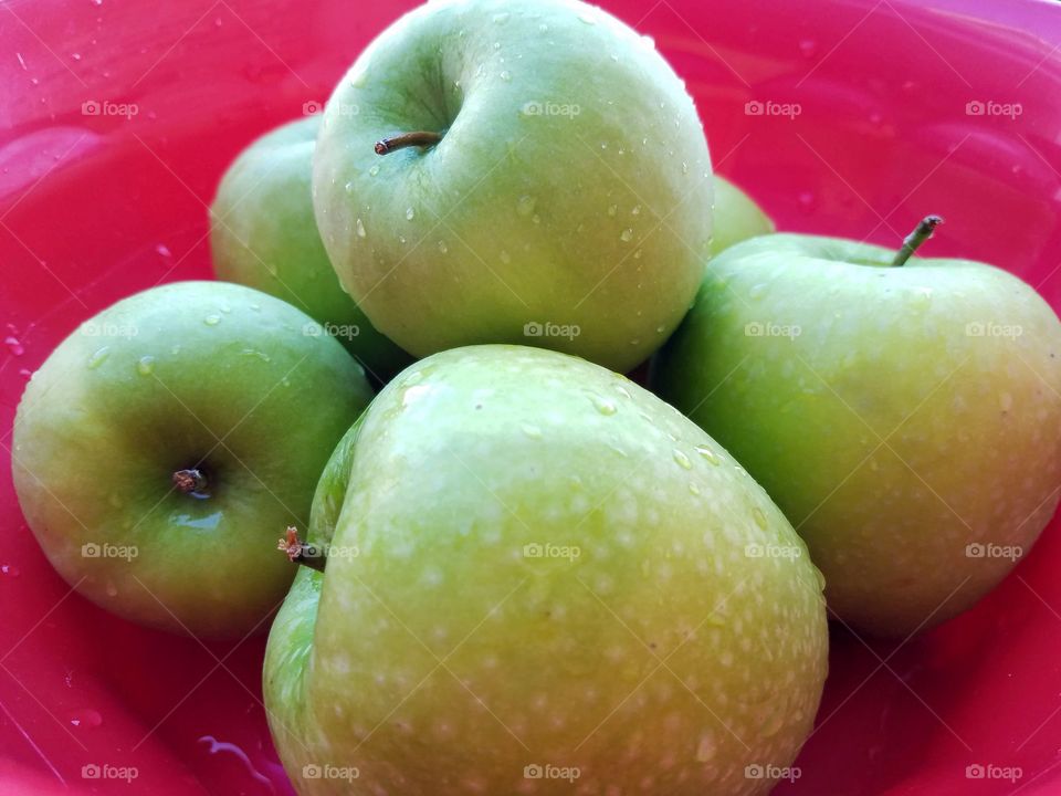Crisp Green Apples in Red Bowl
