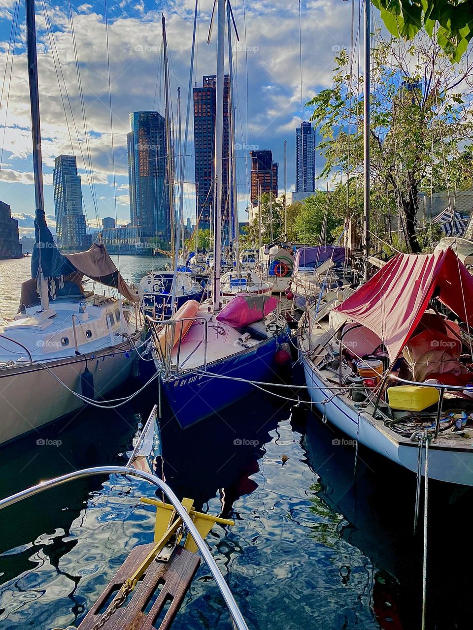 This is “Newtown Creek” by the “Pulaski Bridge” in LIC, Queens. In the late afternoon the sun begins to set and sometimes bathes an entire area in an intense orange golden glow as is the case here with these boats. 2023. Hypnotic Productions