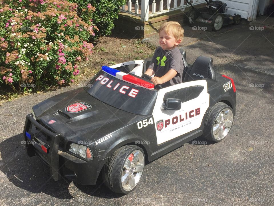 Boy playing in toy car