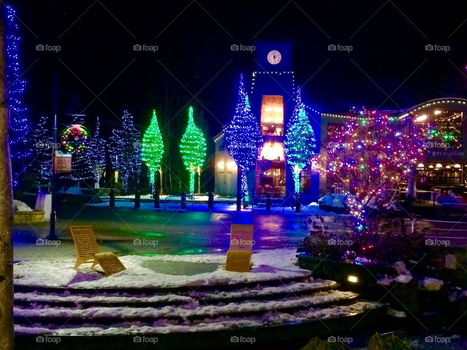 A sweet little spot for two, overlooking a frozen pond, surrounded by Christmas Lights reflected against a light dusting of snow.
