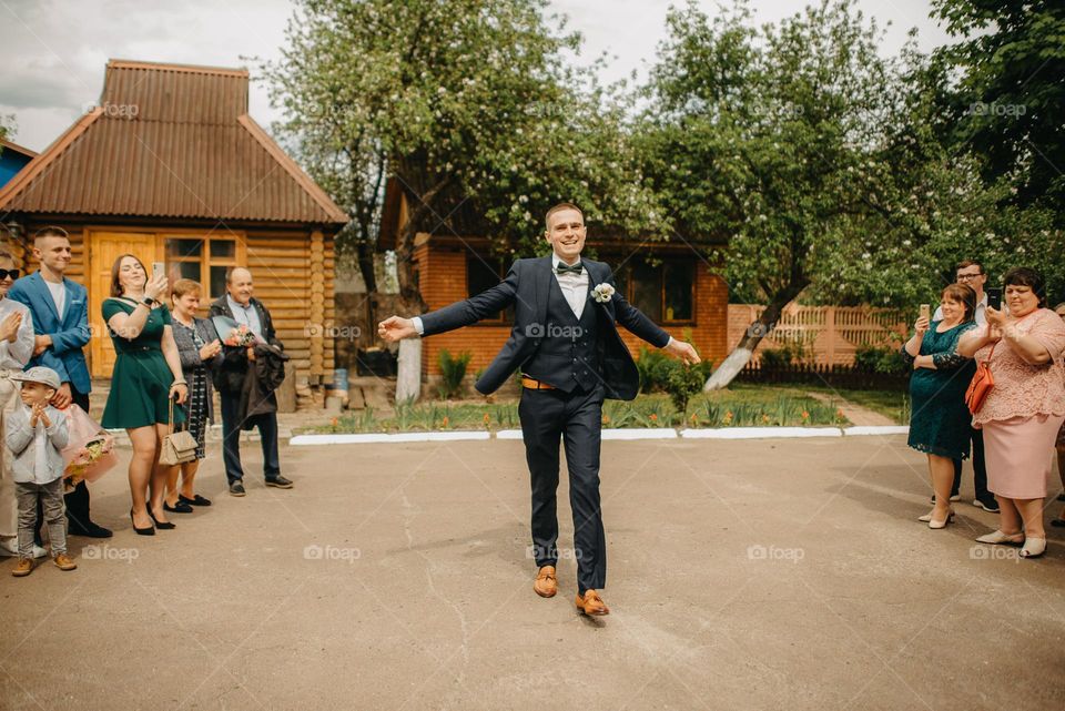 The happy groom goes to the bride