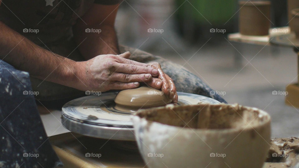 Potter's hands making pottery