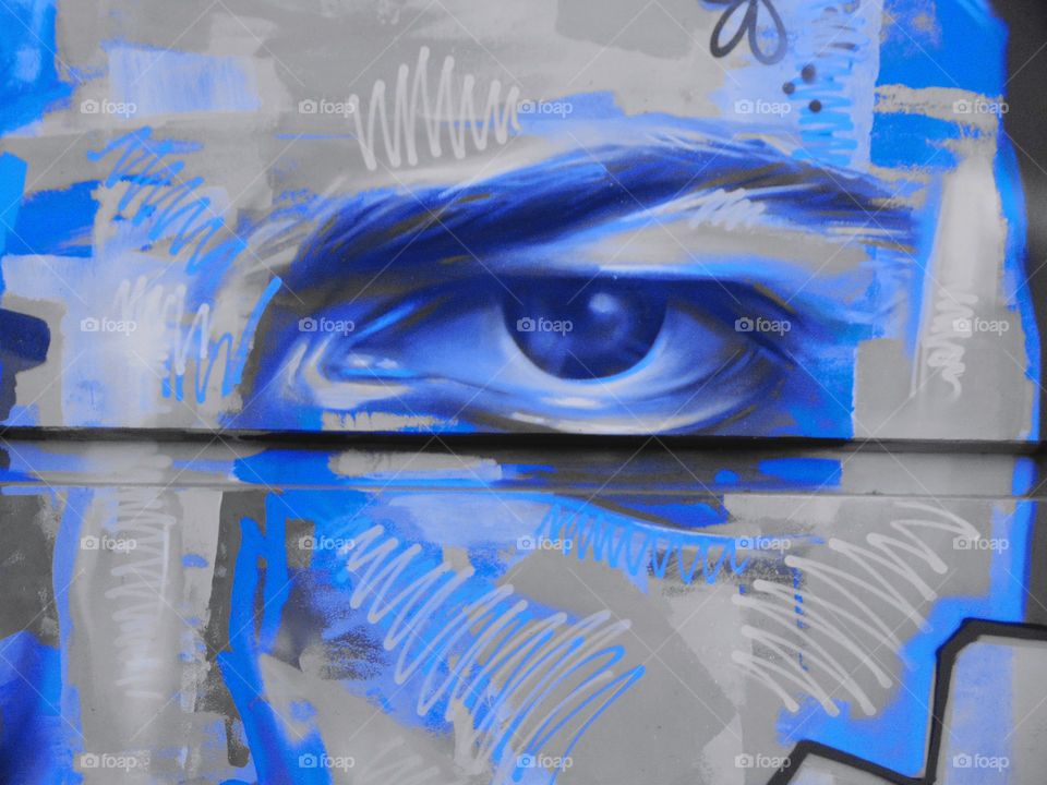 black and blue graffiti street art on the side of a building