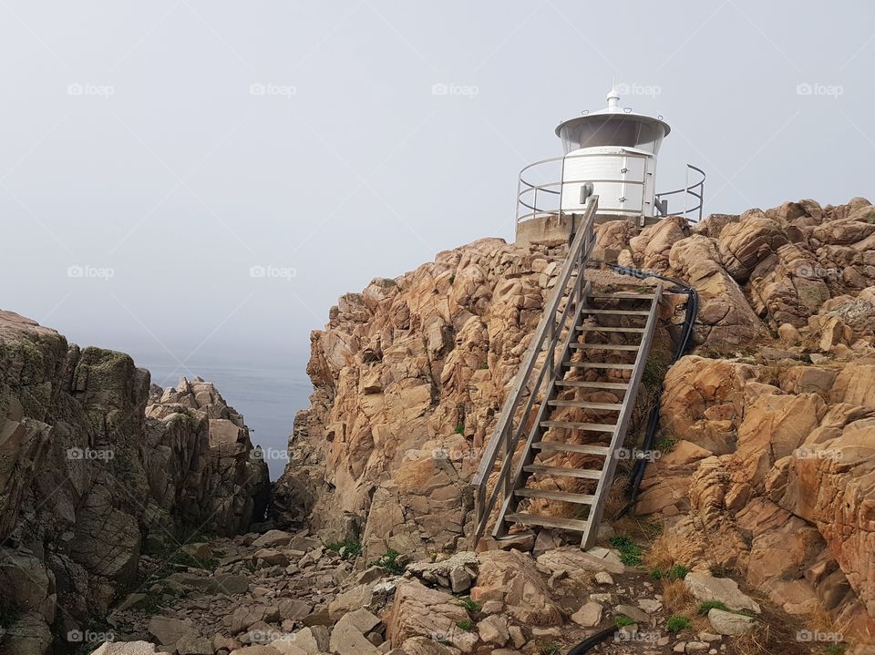 White lighthouse on the rocks