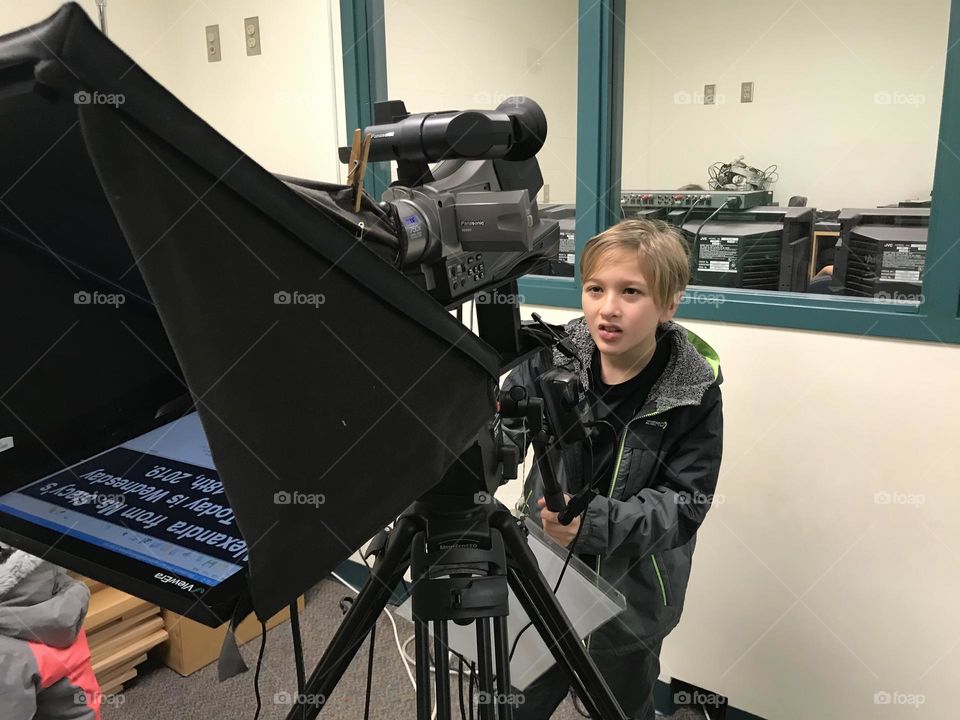 Boy behind camera during TV crew