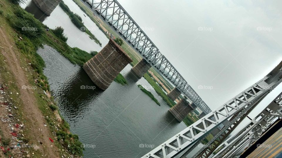 a railway bridge from another one on a river