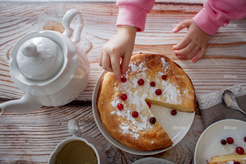 Children breakfast with cheesecake. Hands, detail