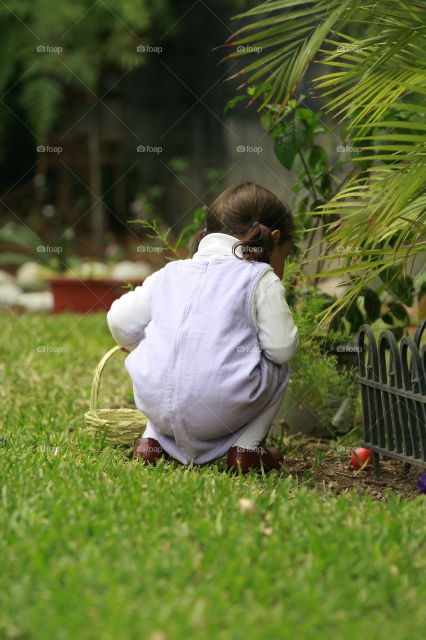 Small girl easter egg hunting