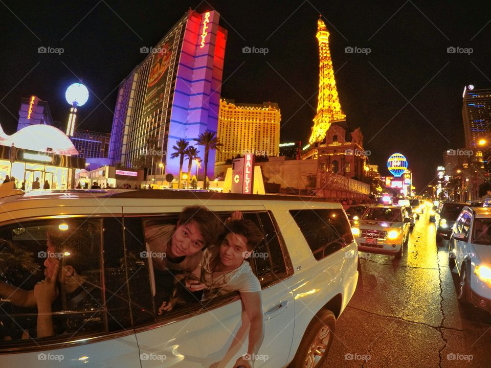 Two man looking out of car in car at night