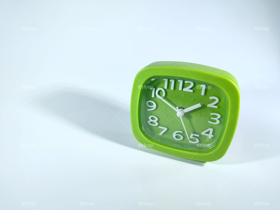 Green clock with white background.