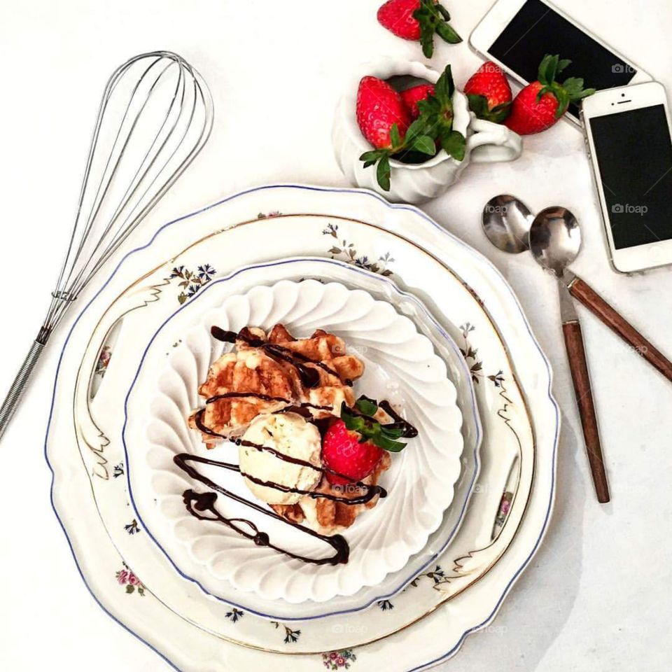 High angle view of mobile phones with ice cream