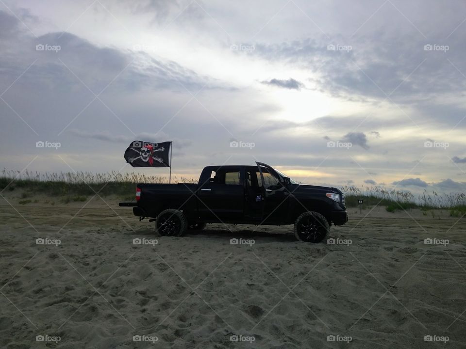 Black truck on the beach