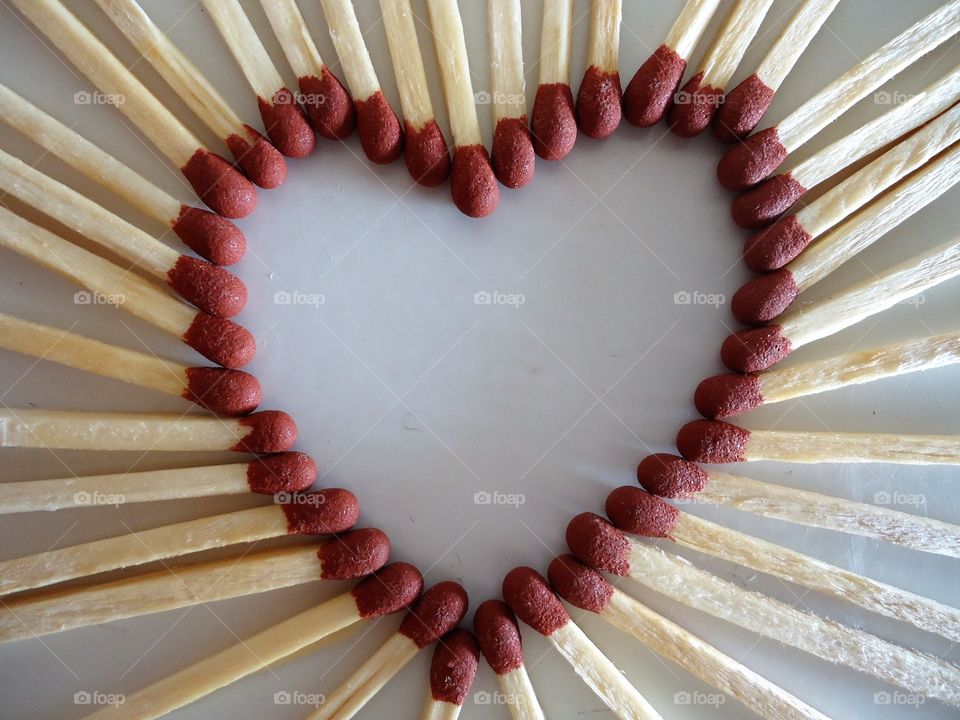 heart of matches red head and wood sticks