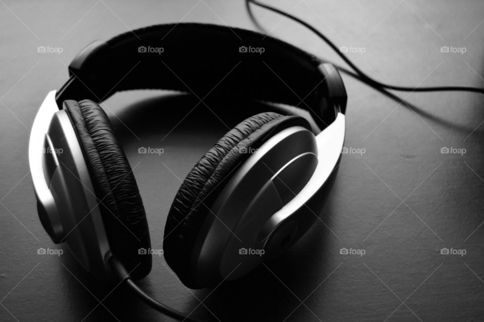 Headphones on a desk. Simple, natural black and white picture.