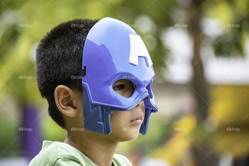 Asean boy blue mask Background green tree