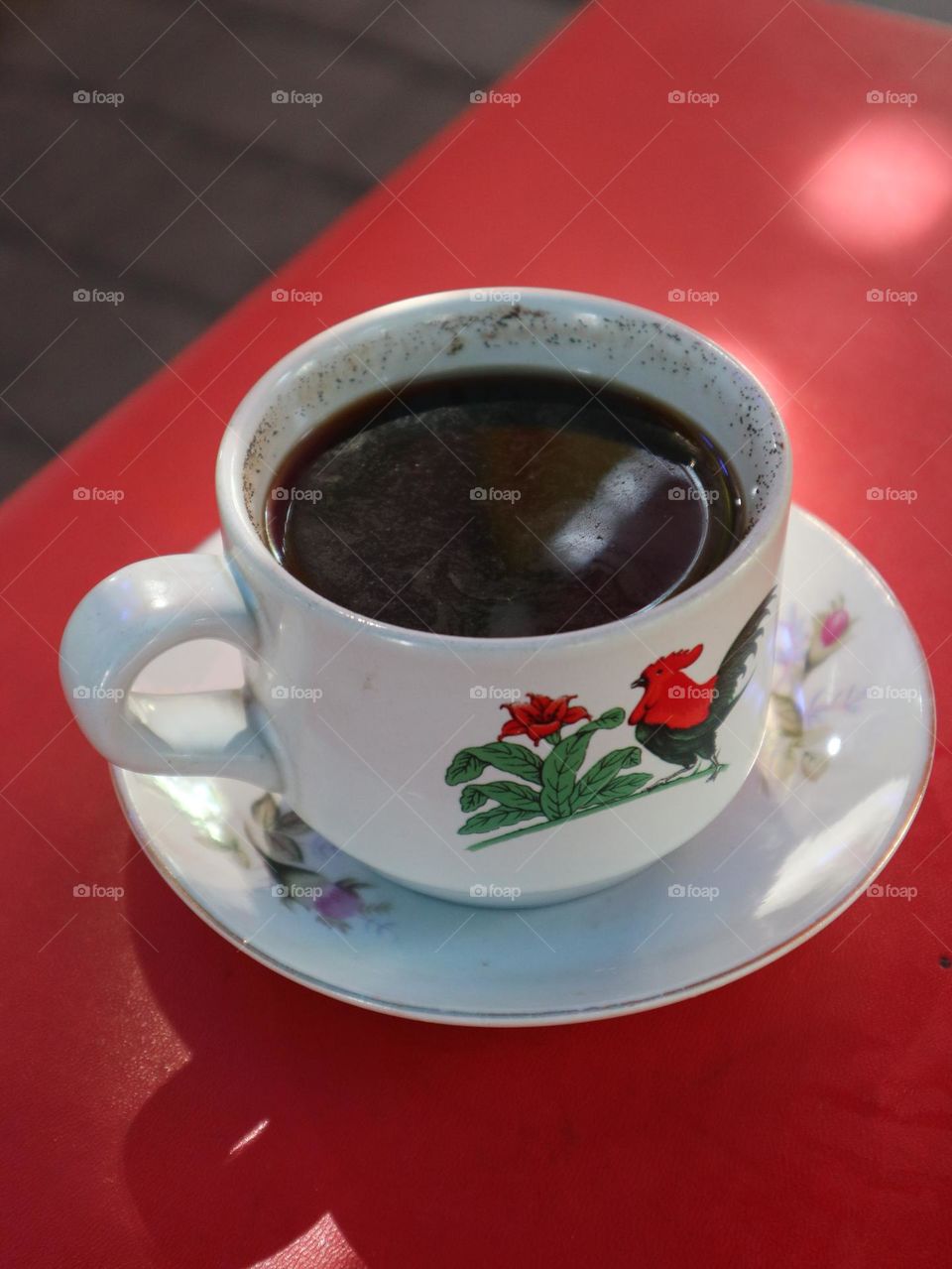 Black coffee in a rooster cup