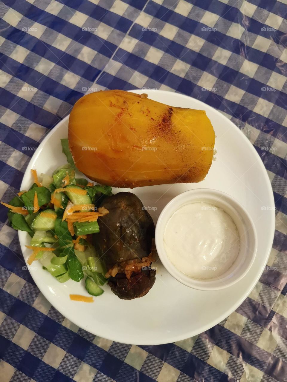 A meal of pumpkin stuffed with white rice, pedigan and salad