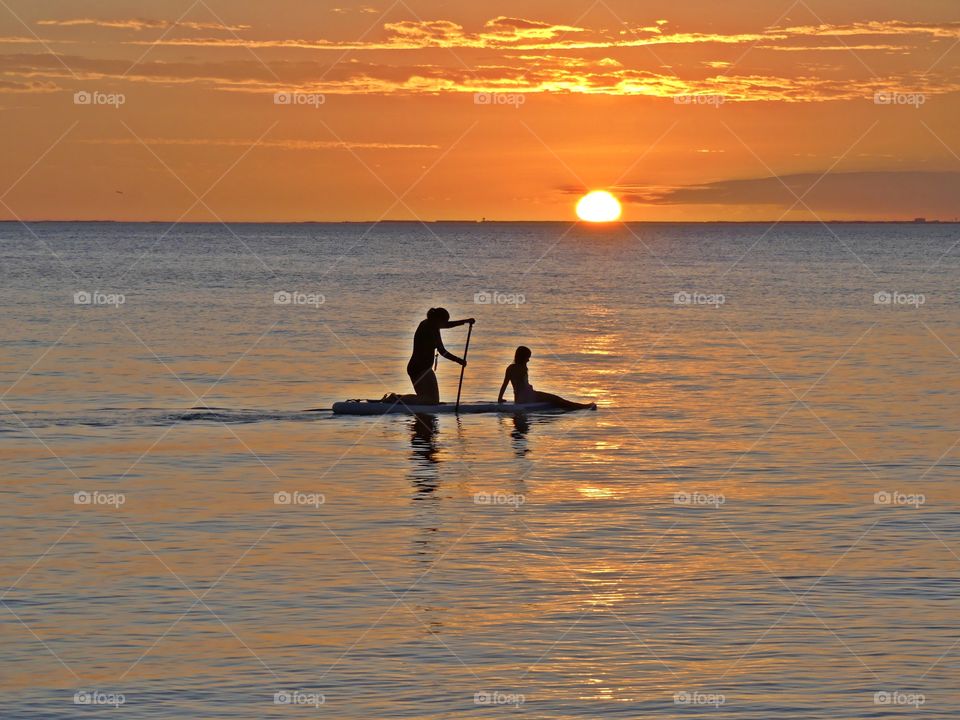 

Sunset vs Sunrise  - silhouette of Sisters paddle boarding in the bay - The Golden Hour offers plenty of opportunities for great photos, and the really beautiful thing is that it happens twice a day