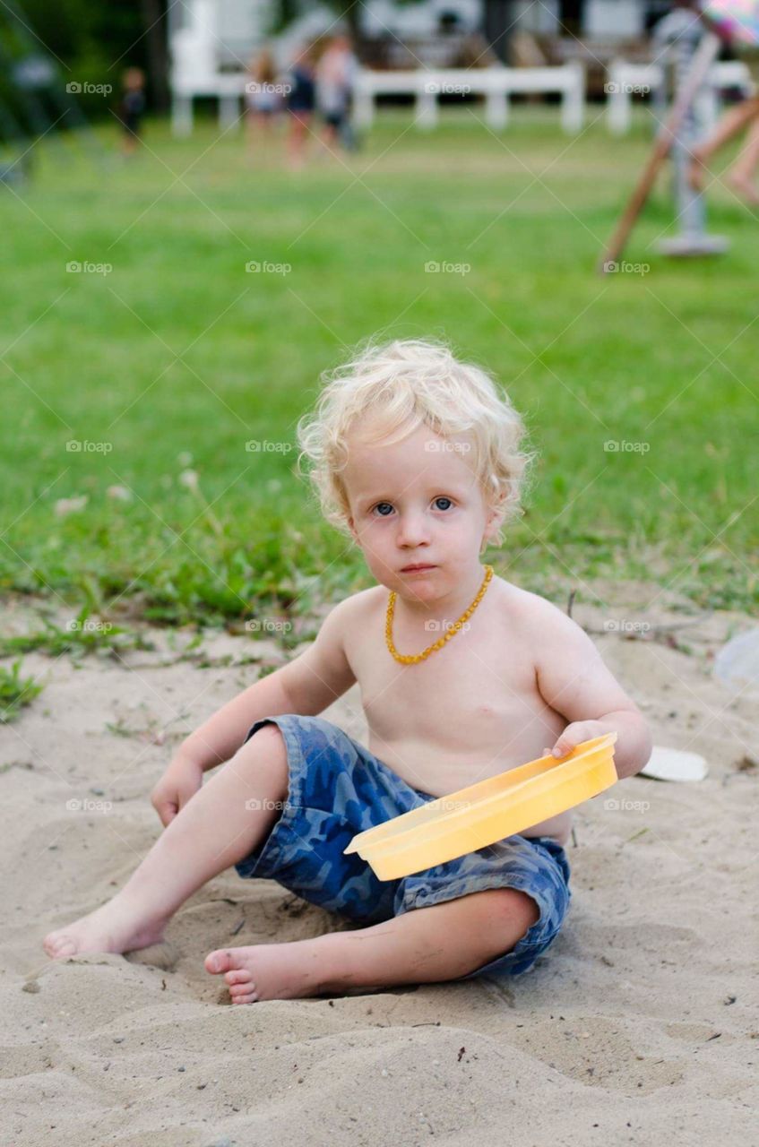 toddler playing in sand
