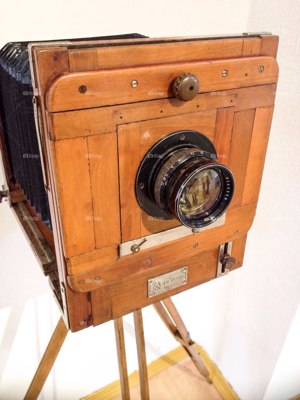 Wooden classic retro camera on tripod