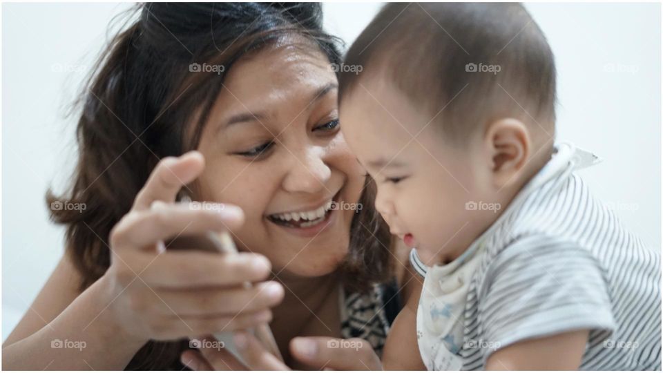 Cute Asian baby play with his mom