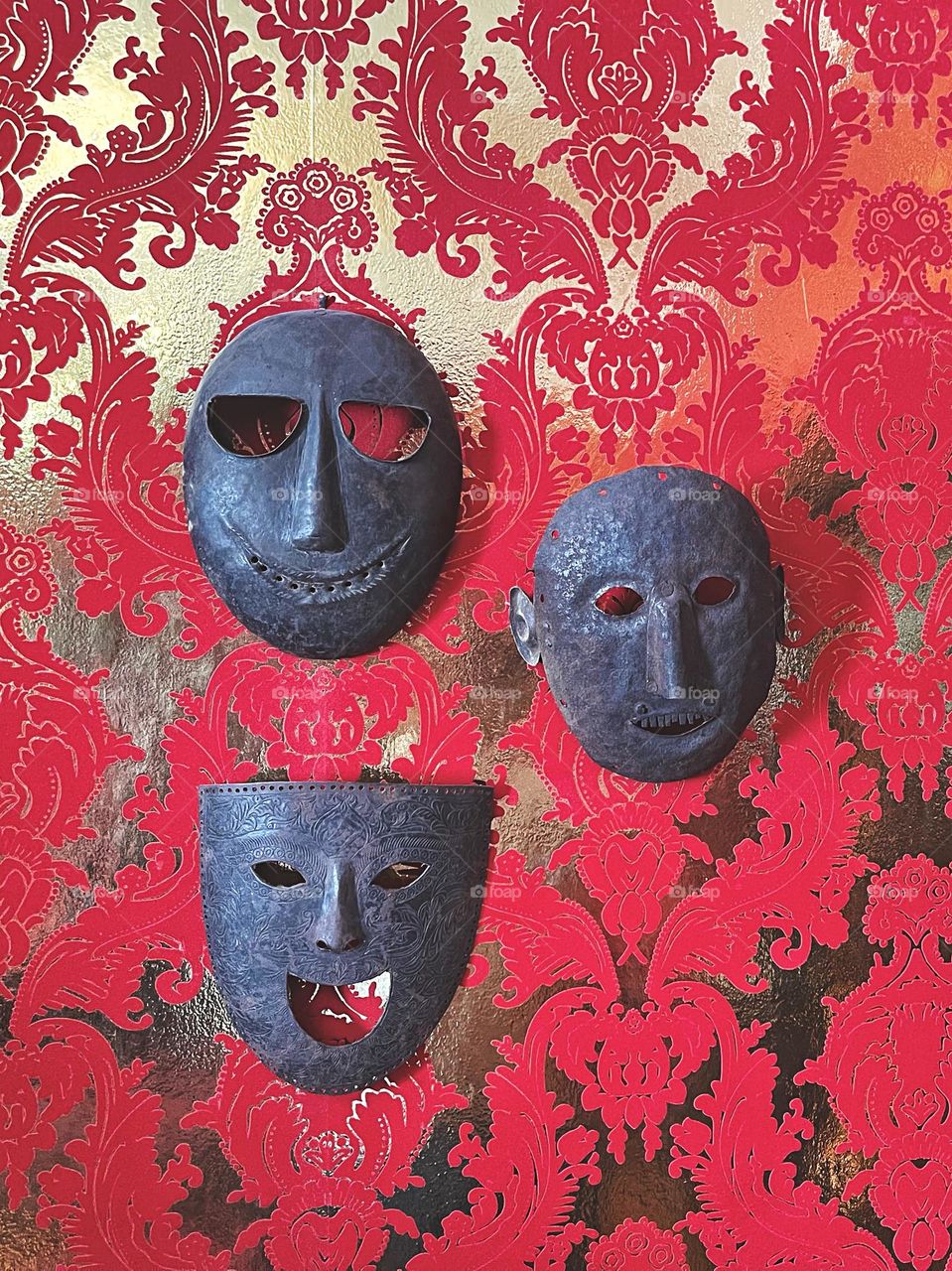 Metal face masks on a wall 