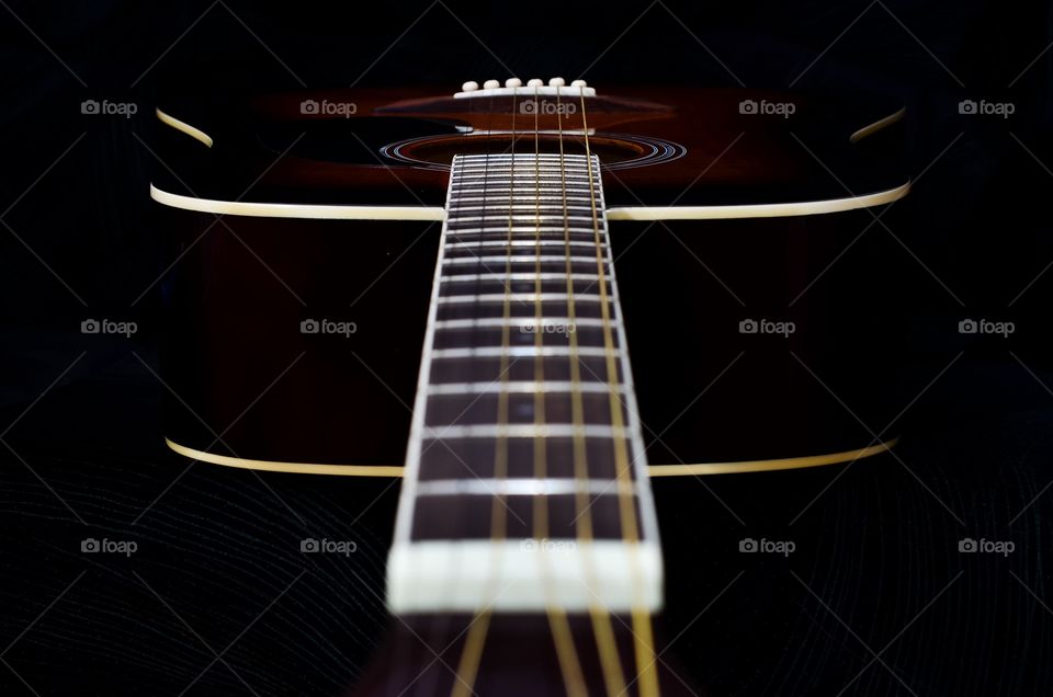 Looking down the neck of an acoustic guitar