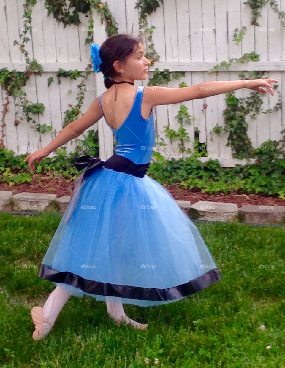 Teenager girl dancing at backyard