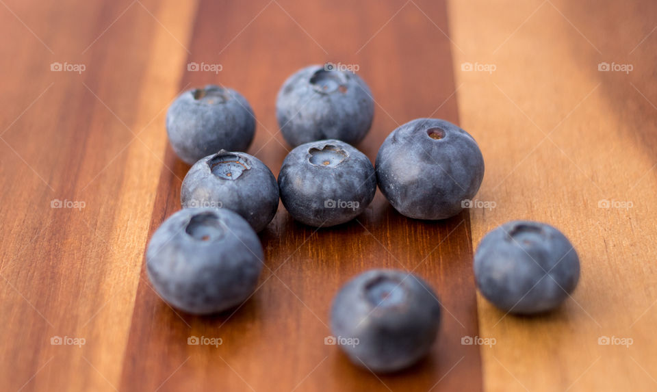 Fresh blueberries close up on cutting board 