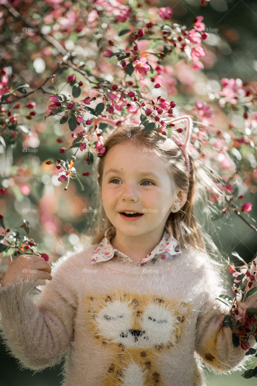 Cute Little girl in a blossom park