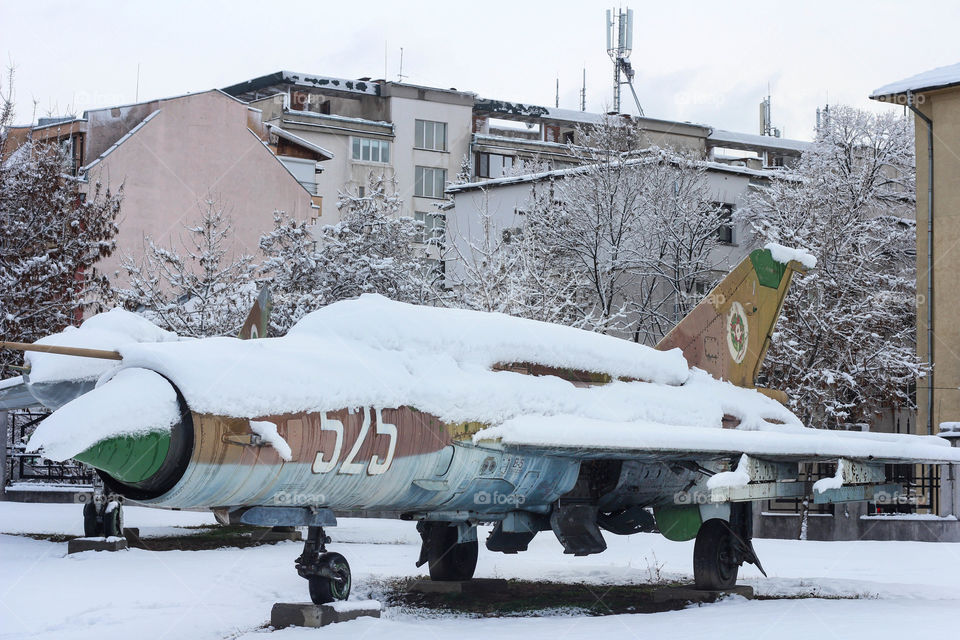 Military aircraft covered with snow