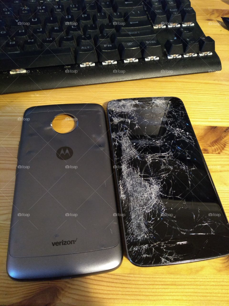 A damaged Motorola cellphone, run over by a car.