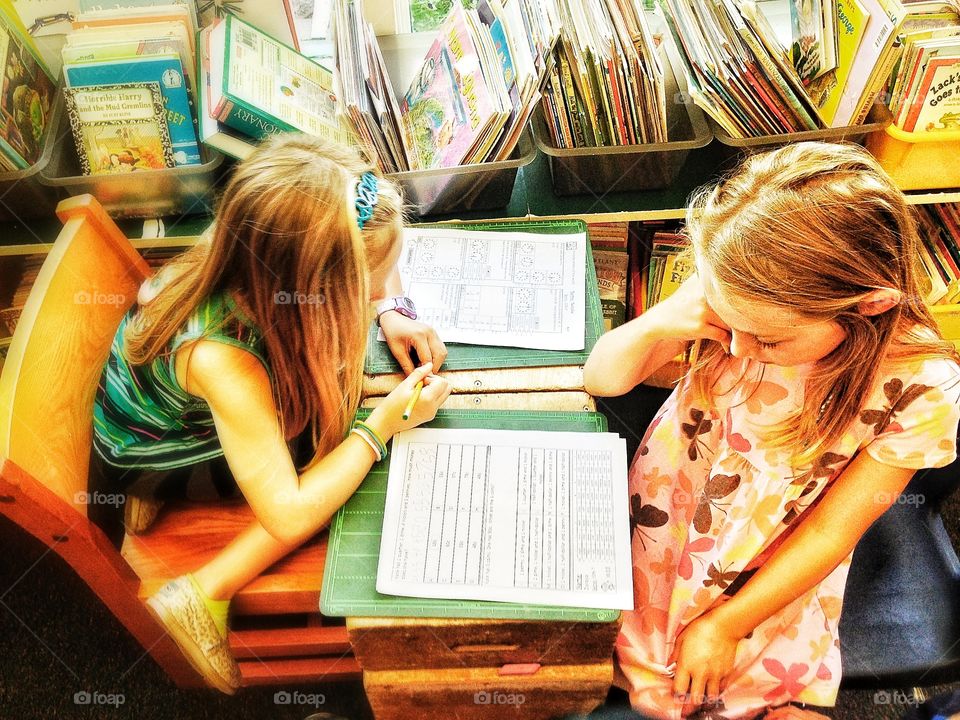 Desk From Above. Children Studying At A Classroom Desk
