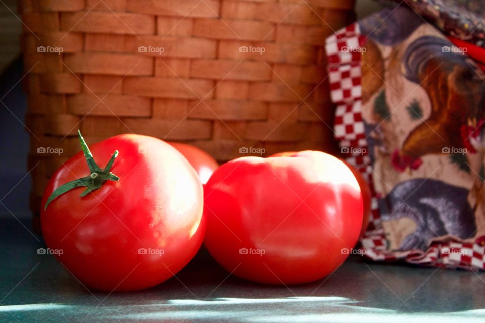 Still life of fresh tomatoes on a kitchen counter in the sunlight