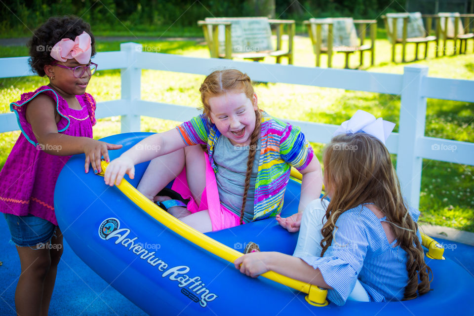 Girls Playing at the Park on a Raft