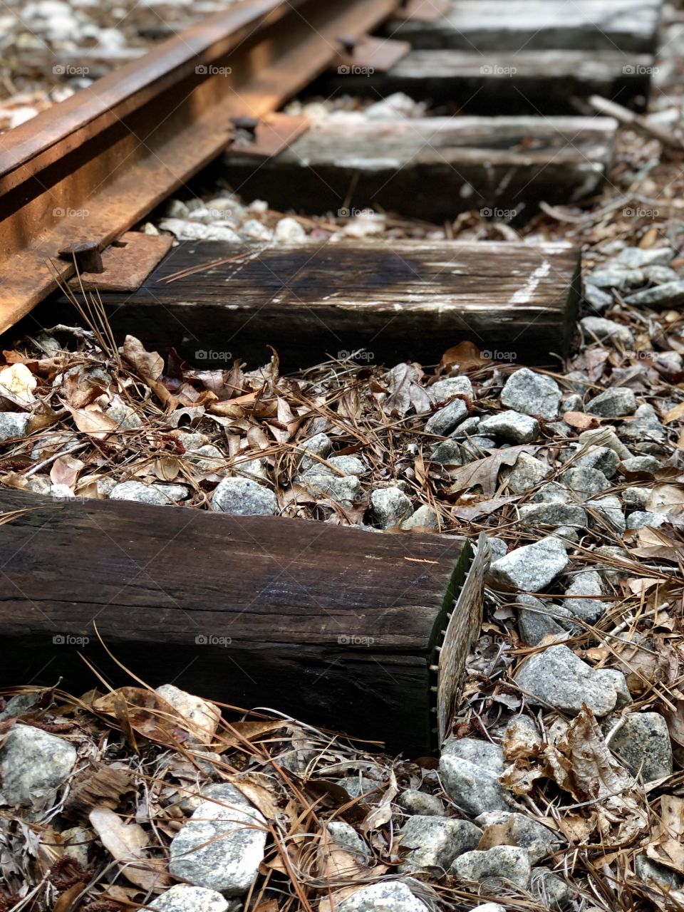 Closeup old railroad timber’s and iron rail with gravel