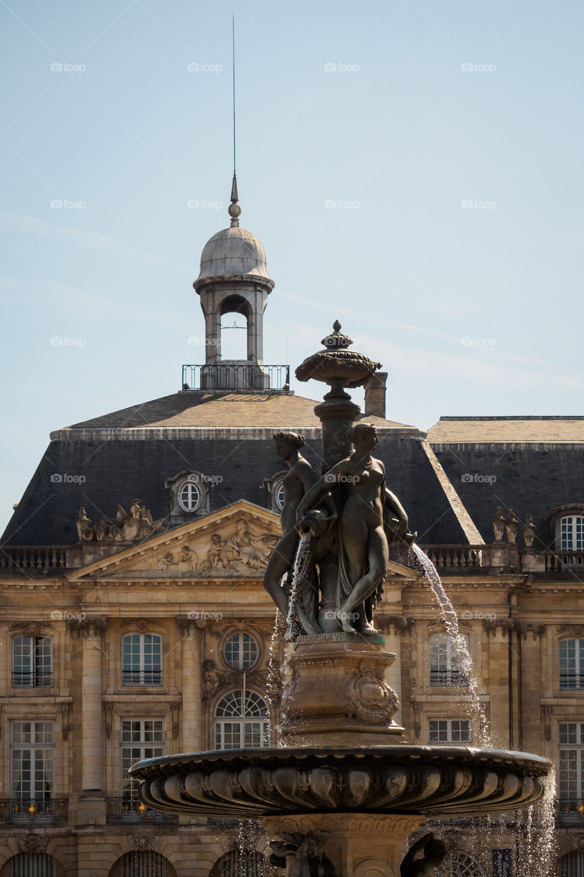 Statues of the fountain and facade of the stock exchange in Bordeaux, France 