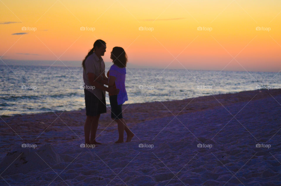 Couple on the beach at sunset