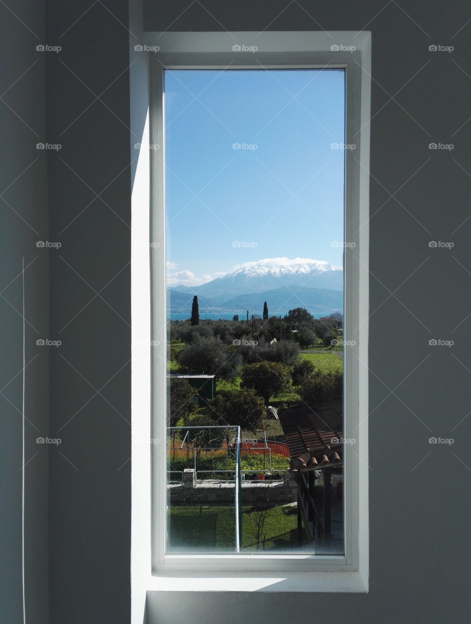 landscape with trees and mountains through slim window view