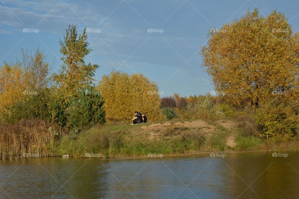 family mother and son resting on a lake shore beautiful nature landscape best place for relaxing