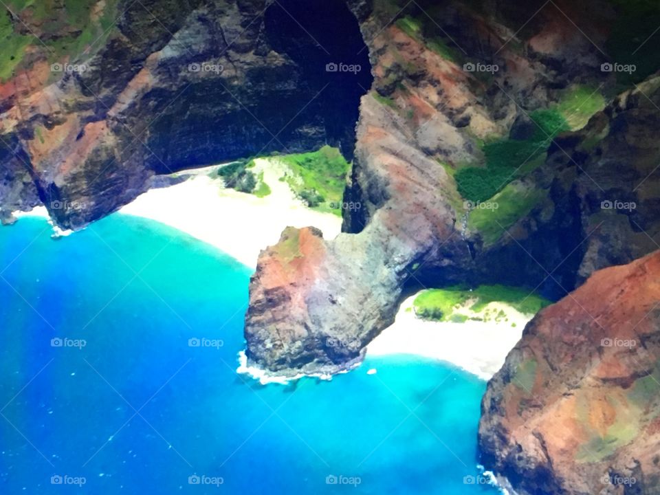 A tiny beach hidden away by the walls of the Nepali Coast on the island of Kauai, Hawaii.