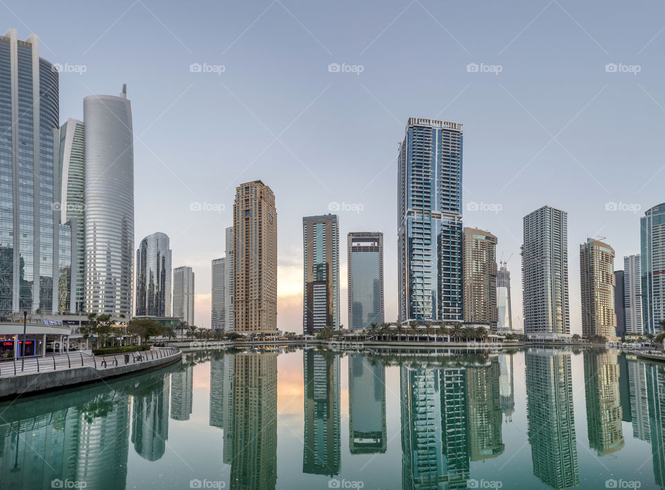 Sunset at Jumeira Lake Towers in Dubai with reflection in the lake