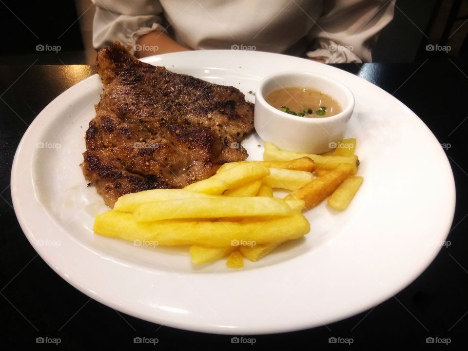 Making a pork steak.