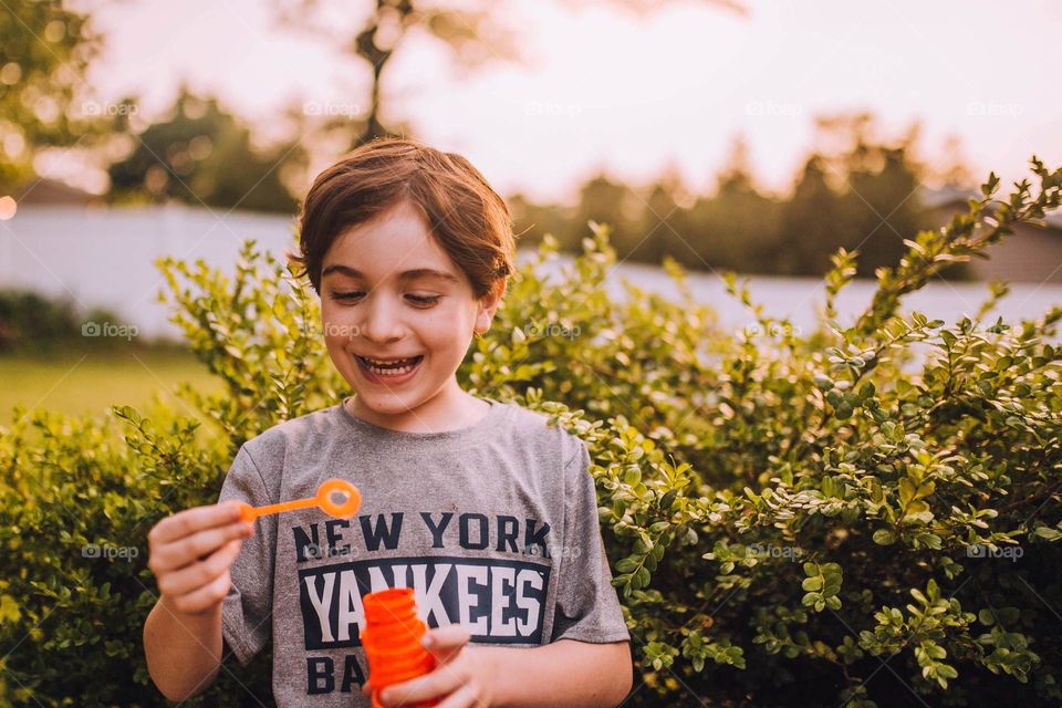 Boy blowing bubbles