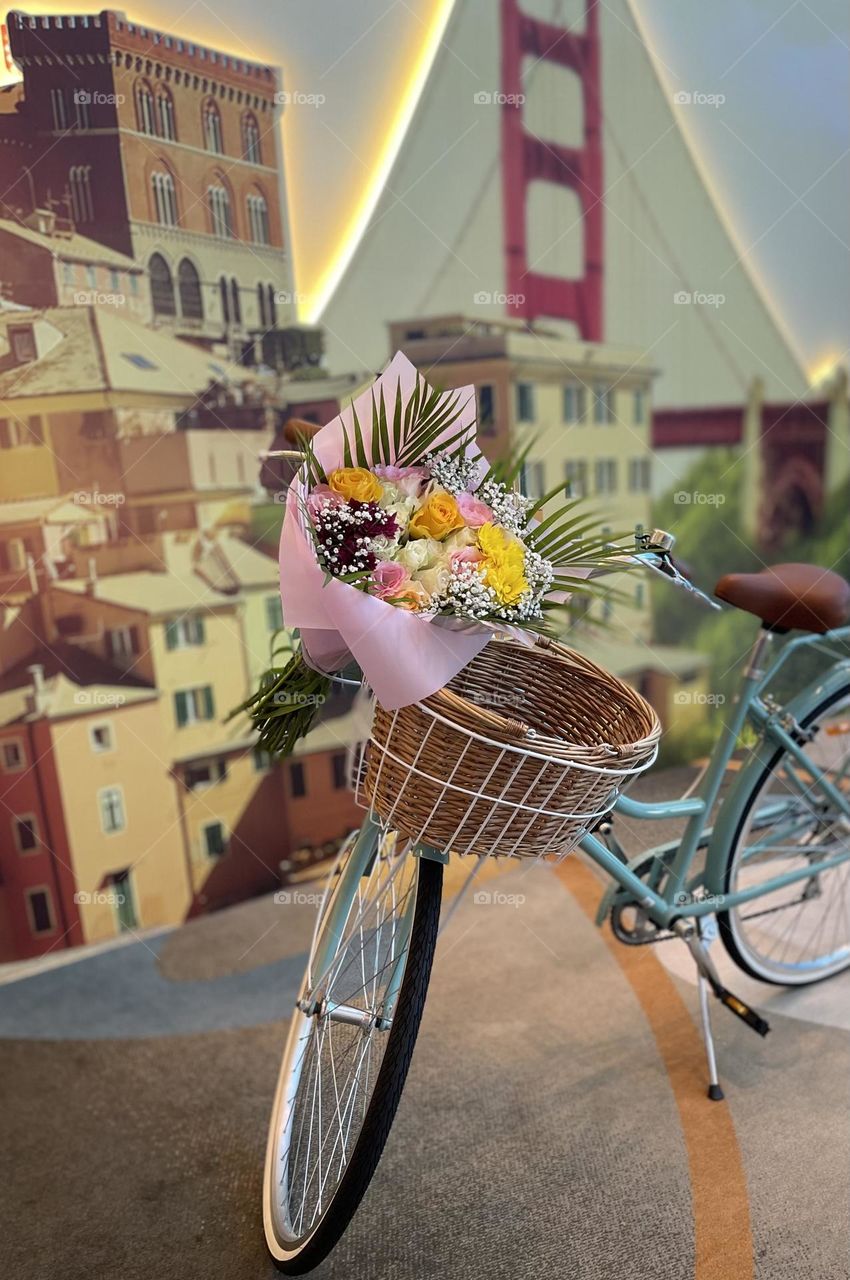 The bluish bike with flowers