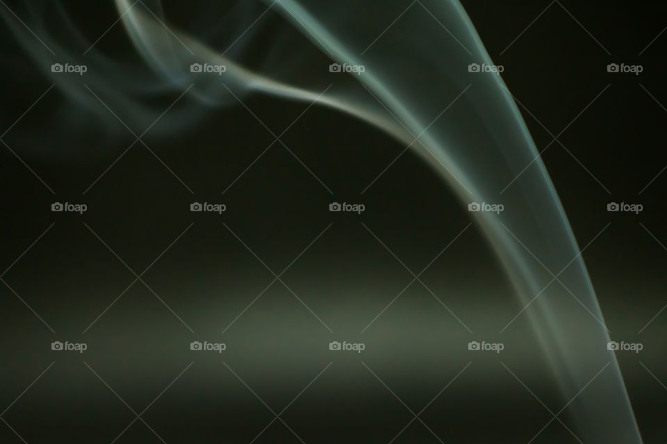 Smoke scented candles on a black background