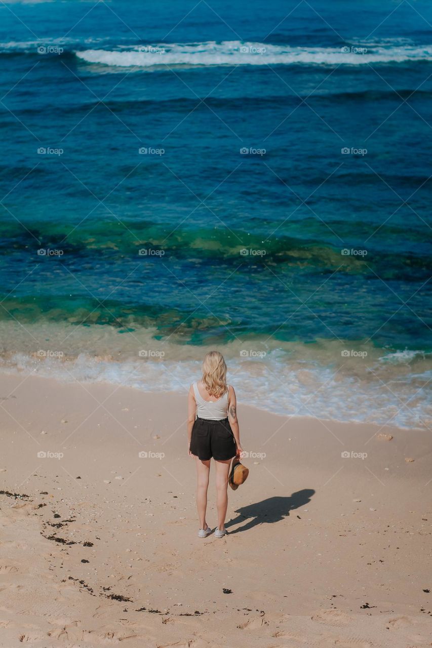 standing in front of the beach in summer dress