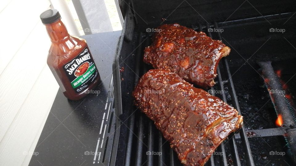 Ribs. baby backs with some Applewood rub and JD sauce! Yum!