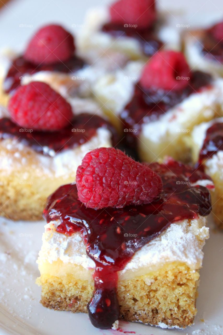 Slice of cake with raspberries in plate