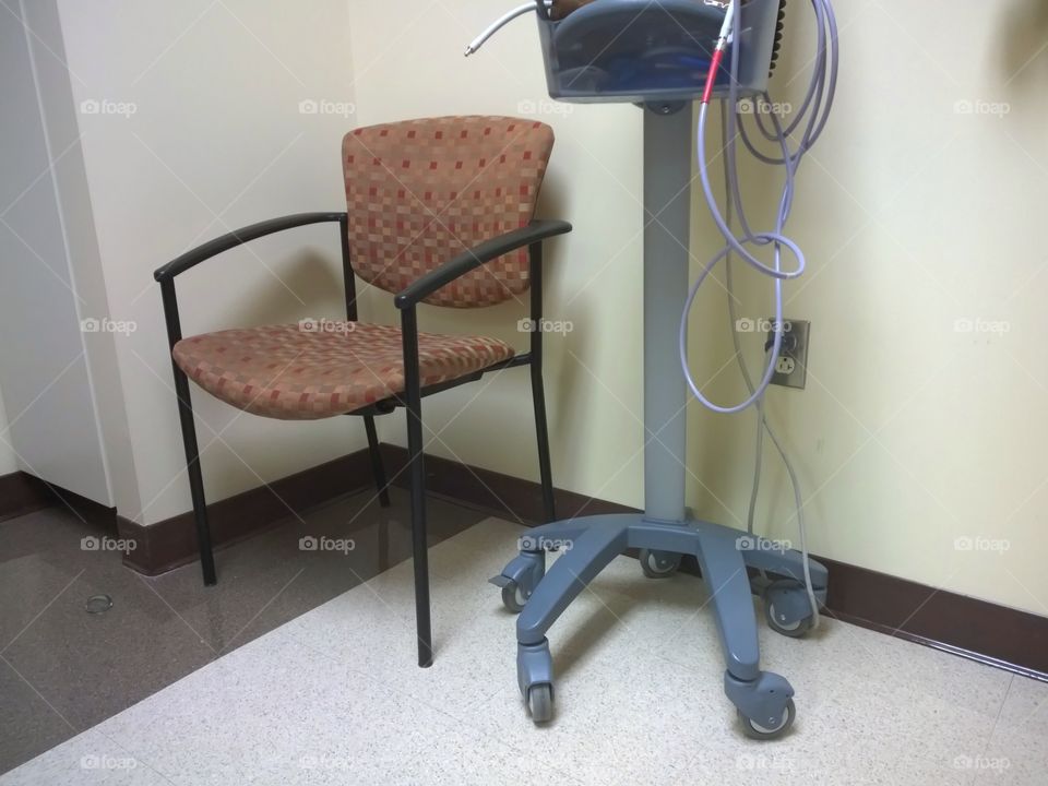 Chair in a hospital room/check up room.